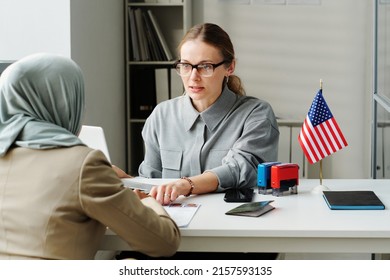 Consular Officer Working With Muslim Woman - Shutterstock ID 2157593135