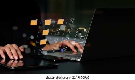 IT Consultant Installing Document Management System (DMS) On Laptop Computer With Document Directory. Archiving, Finding, And Managing Business File Information Software