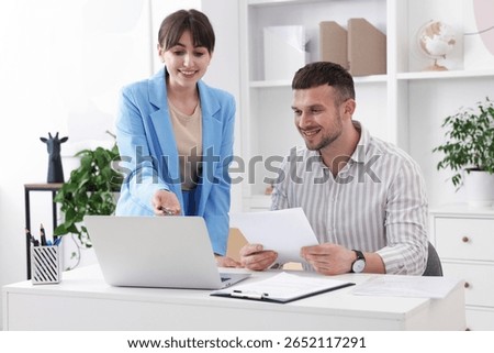 Consultant working with client at table in office. Business meeting