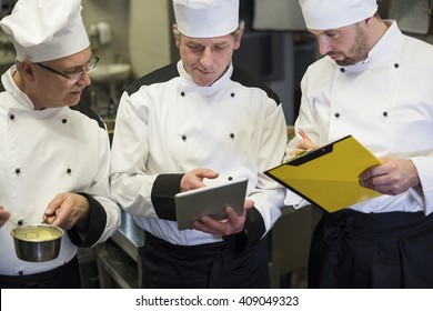 Consultation of chefs in the kitchen - Powered by Shutterstock