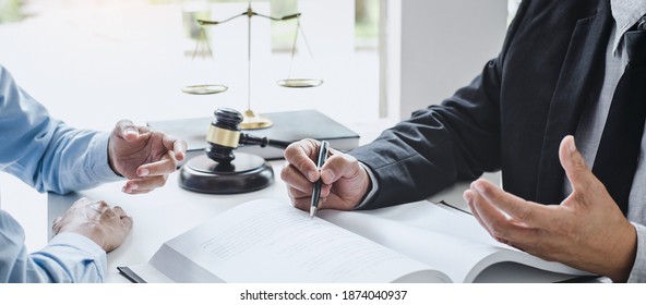 Consultation and conference of Male lawyers and professional businesswoman working and discussion having at law firm in office. Concepts of law, Judge gavel with scales of justice. - Shutterstock ID 1874040937