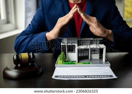 Consultation, contract agreement, lawyer focused on court hammer sitting on chair with client's indictment to settle home and land in court house auction concept