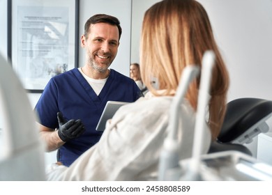 Consultation of the dentist and the patient in the cabinet - Powered by Shutterstock