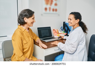 Consultation With Experienced Female Audiologist To Mature Woman Patient At Medical Clinic. Treatment Of Hearing Loss In Senior People