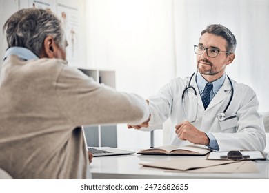 Consultation, man and doctor in office with handshake, help and agreement for health insurance. Clinic, senior patient and medical professional shaking hands with support, thank you and healthcare - Powered by Shutterstock