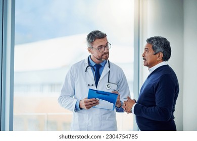 Consultation, medical and doctor talking to patient and writing notes on a clipboard for diagnosis in a clinic. Medicine, healthcare and professional man consulting person with health insurance - Powered by Shutterstock