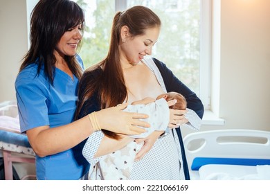 Consultation On Breastfeeding With A Lactation Consultant At Hospital. A Doctor Watching A New Mother Feed The Baby With A Breast.