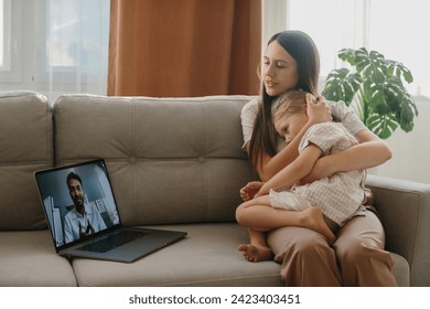 Consultation with a pediatrician online. A young mother with a sick child makes a video call to her doctor. - Powered by Shutterstock