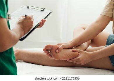 Consultation physiotherapist with the treatment of treating injured ankle pain in modern clinics.Concept of physical rehabilitation.