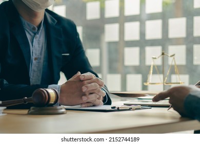 Consulting of businessmen and male lawyers or judges counselors whose teams meet with clients with hammers and goddess scales placed next to them. Legal Service Concepts