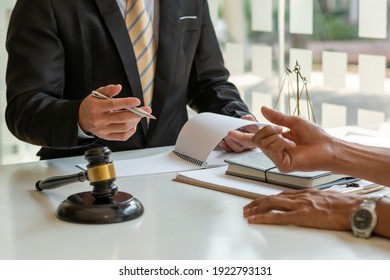 Consulting and finding a solution Concept, businesspeople consult with a lawyer or judge to find out about business fraud. - Shutterstock ID 1922793131