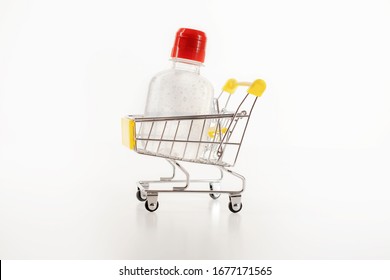 Consumer Buying Panic About Coronavirus Covid-19 Concept. Sanitizer Antiseptic Gel In Shopping Trolley Isolated. People Are Stocking Up Essentials For Home Quarantine.