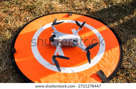 Consumer drone touching down on the landing pad.
