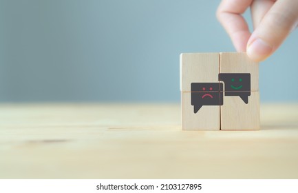 Consumer feedback concept.  Customer satisfaction evaluation to improve and develop product and service. Customer centric.  Hand put wooden cubes with "smile" "sad" icon on grey background ,copy space - Shutterstock ID 2103127895