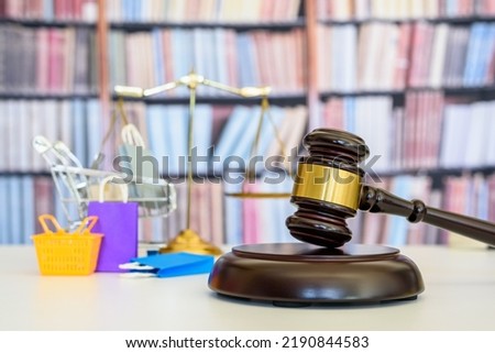 Consumer protection law, rights and guarantees, justice concept : Judge gavel, balance scale, bags, a shopping cart, depicting a safeguard designed to protect buyers from fraudulent business practices