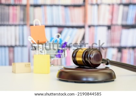 Consumer protection law, rights and guarantees, financial justice concept : Judge gavel, bags in a shopping cart, depicting a safeguard designed to protect consumers from fraudulent business practices