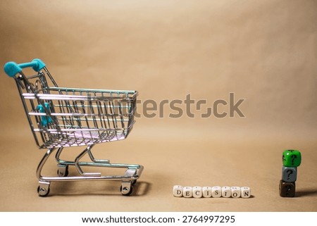 Consumer purchase decision concept with mini shopping cart and word decision made of wooden cubes, copy space background