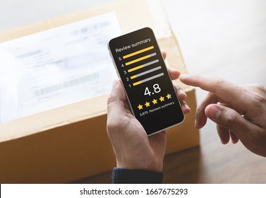 Consumer Reviews Concepts With Young Person Putting Report Score On Application Smartphone And Packaging Product Behind.rating Or Feedback.business Online Shopping And Delivery