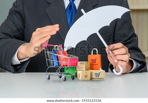 Consumer rights and consumer protection, business\
law concept : Buyer or purchaser protects bags and boxes of goods\
purchased online from internet retailer website, depicts caring on\
products bought
