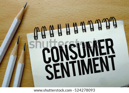 Consumer Sentiment text written on a notebook with pencils