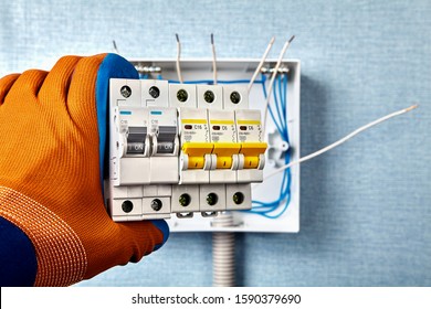 Consumer Unit Of Electrical Wiring Installation Which The Installed In Residential Home. An Electrician Install The Fuse Box Or Circuit Breaker Inside Electric Cabinet. Repairman Mount A Switchboard.