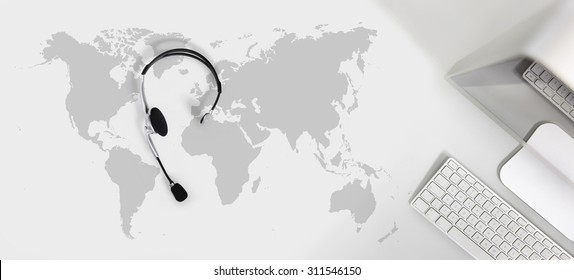 contact global concept , top view desk with headset, computer and map - Shutterstock ID 311546150
