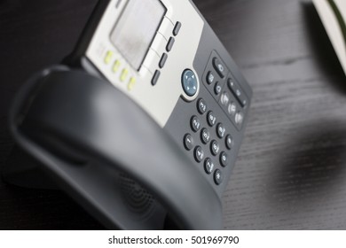 Contact Information - Office Phone Sitting On Wooden Desk