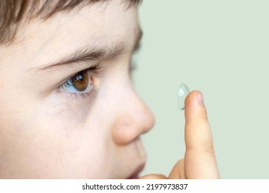 Contact Lens For Kids,safe To Wear.cute Little Boy Putting One Silicone Contact Lens,holding Finger Close Up To The Eye.vision Correction,ophthalmology For Children's Concept.isolated Space For Text 