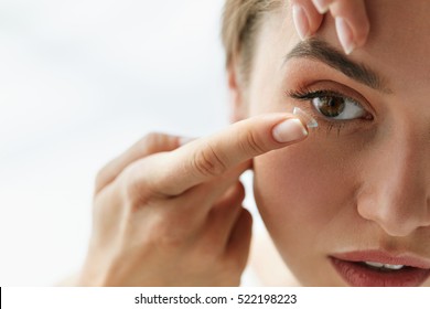 Contact Lens For Vision. Closeup Of Female Face With Applying Contact Lens On Her Brown Eyes. Beautiful Woman Putting Eye Lenses With Hands. Opthalmology Medicine And Health. High Resolution 