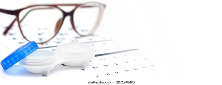 Contact Lenses Case And Eye Glasses On And Eye Test Chart. Vision Concept. Way To Improve Vision