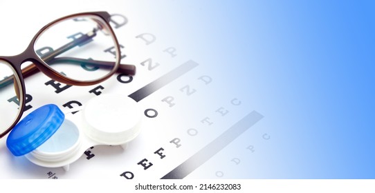 Contact Lenses Case And Eye Glasses On And Eye Test Chart. Vision Concept. Way To Improve Vision