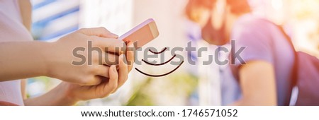 contact tracing app COVID-19 Pandemic Coronavirus Mobile Application - people Wearing Face Mask Using Smart Phone App in City Street to Aid Contact Tracing in Response to the 2019-20 Coronavirus