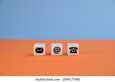 Contact us concept with mail, e-mail, and phone icons on cubes. Contact methods. Orange and blue backgrounds.  - Shutterstock ID 2044177685