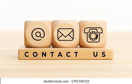 Contact us concept. Wooden blocks with email, mail and telephone icons.Website page contact us or e-mail marketing