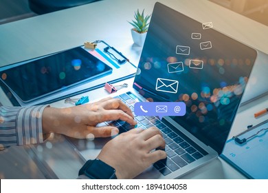 Contact us or Customer support hotline people connect. Businessman using a mobile phone with the (email, call phone, mail) icons. - Shutterstock ID 1894104058