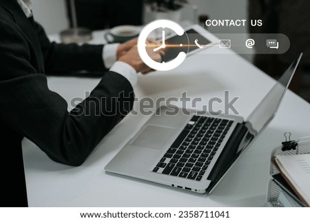 Contact us or Customer support hotline people connect. Businessman using a laptop and touching on virtual screen contact icons. Contact Us Customer Support Inquiry Hotline Concept.
