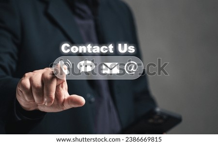 contact us or Customer support hotline service. Businessmen use mobile phones to find company contact information from the internet, addresses, online mail, chat inquiries, telephone numbers.