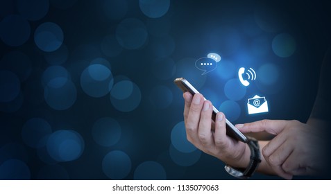 CONTACT US, Hand of a businessman holding a mobile smartphone with the icon. Contact us connection concept with copy space. - Shutterstock ID 1135079063