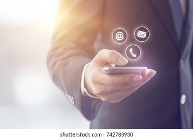 CONTACT US, Hand of Businessman holding mobile smartphone with ( mail,phone,email ) icon. cutomer support concept, copy space. - Shutterstock ID 742783930