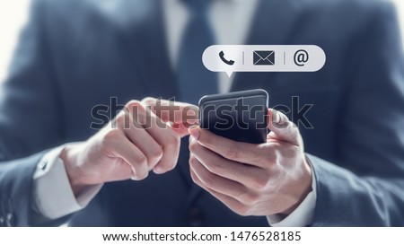 CONTACT US, Hand of Businessman holding mobile smartphone with ( mail,phone,email ) icon. customer support concept, copy space.
