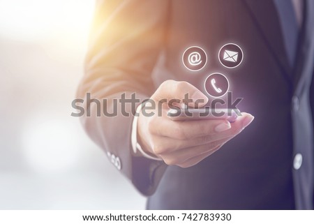 CONTACT US, Hand of Businessman holding mobile smartphone with ( mail,phone,email ) icon. cutomer support concept, copy space.