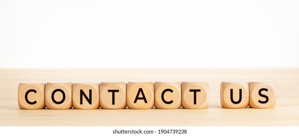 Contact Us Word On Wooden Blocks On Wood Table. Copy Space. White Background