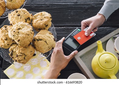 A Contactless Card Payment Is Being Made In A Cafe. 