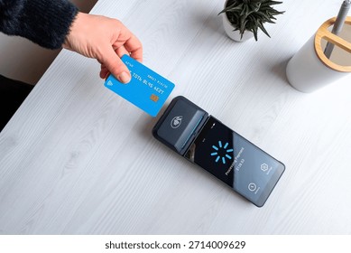 Contactless card payment processing on POS terminal with loading screen, representing digital transaction, payment verification, and modern fintech workflow