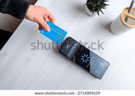 Contactless card payment processing on POS terminal with loading screen, representing digital transaction, payment verification, and modern fintech workflow