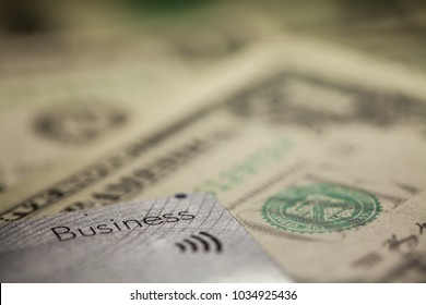 Contactless Credit Or Debit Card With US Dollar Bills, Business Written On The Side Of The Card, Copy Space For Adding Custom Text Or Illustration