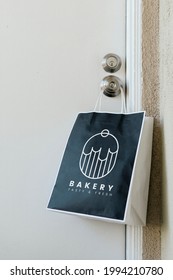 Contactless Delivery Bakery Bag Mockup Hanging On A Doorknob During The Coronavirus Pandemic