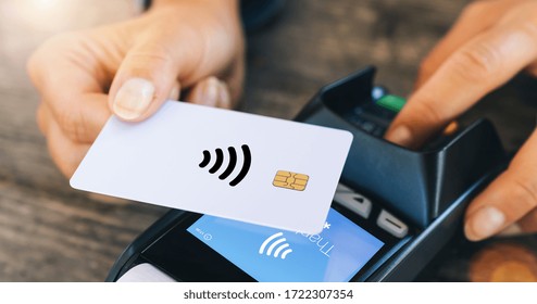 Contactless payment concept, female customer holding credit card near nfc technology on counter, client make transaction pay bill on terminal rfid cashier machine in restaurant, close up view