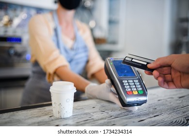 Contactless payment with debit card, coffee shop open after lockdown.