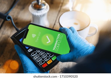 Contactless Payment On A Mobile Phone. Close Up Of A Woman Hand Paying Contactless With A Smartphone Screen Application. Hand Holding Smart Device To Pay. Mockup Cellphone Screen.